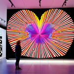 **Interactive Data Visualization Installation:** A museum interior showcasing a large, dynamic data art installation. The artwork responds to the movement and heartbeats of visitors, creating a personalized and evolving experience. Use vibrant colors and futuristic aesthetics. Amsterdam Stedelijk Museum style.
